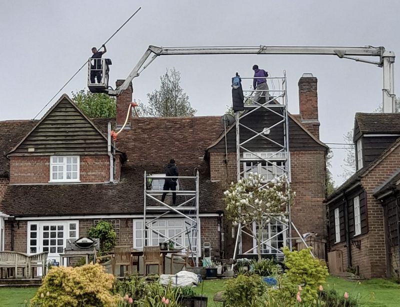 The Roof Moss Cleaners using cherry picker and scaffolding to clean roof safely and professionally in Thame, Oxfordshire
